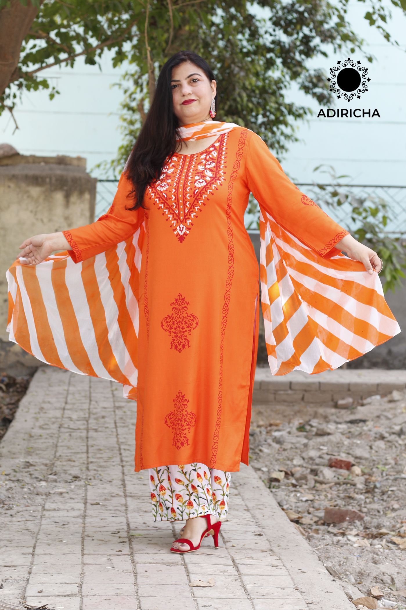 A Pure Spun Silk Orange Kurta With Sharara & Pure Organza Dupatta.